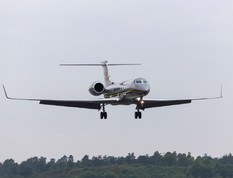 A Gulfstream private jet lands at Farnborough Airport in the UK