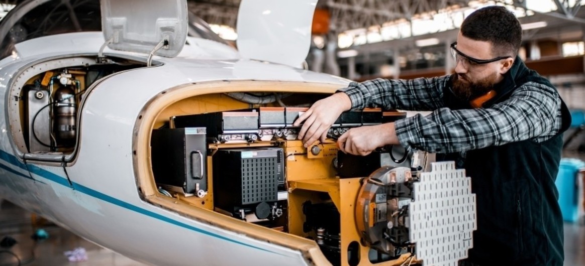 MRO mechanic works on a Cessna Citation business jet nosecone